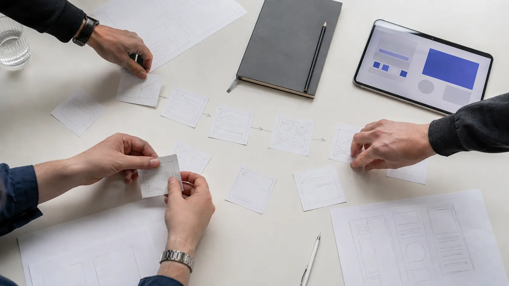 Ilustratīva digitāla produkta struktūras plānošana ar papīra modeļiem un planšeti